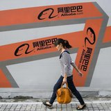 A woman walks past an Alibaba advertisement on a wall in Hangzhou, Zhejiang province September 26, 2013. REUTERS/Chance Chan A woman walks past an Alibaba advertisement on a wall in Hangzhou, Zhejiang province September 26, 2013. REUTERS/Chance Chan