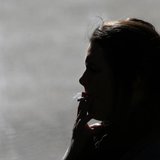 A woman is silhouetted as she smokes a cigarette in central Sydney August 1, 2013. REUTERS/Daniel Munoz A woman is silhouetted as she smokes a cigarette in central Sydney August 1, 2013. REUTERS/Daniel Munoz