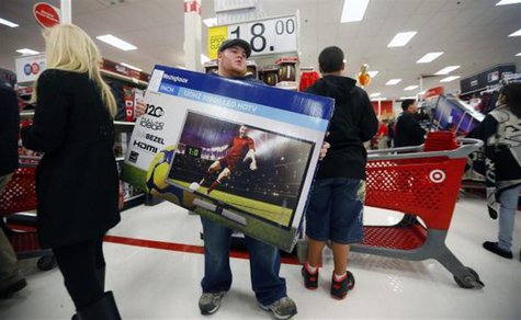 A holiday shopper carries a discounted television to the checkout at the Target retail store in Chicago, Illinois, in this file photo taken A holiday shopper carries a discounted television to the checkout at the Target retail store in Chicago, Illinois, in this file photo taken