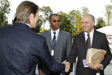 French Finance Minister Francois Baroin (L) shakes hands with socialist party member Laurent Fabius (R) as Ivory Coast's Thierry Tanoh (C), French Finance Minister Francois Baroin (L) shakes hands with socialist party member Laurent Fabius (R) as Ivory Coast's Thierry Tanoh (C),