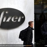 A man walks past the Pfizer logo next to a New York Police Officer standing outside Pfizer's world headquarters in New York November 5, 2013 A man walks past the Pfizer logo next to a New York Police Officer standing outside Pfizer's world headquarters in New York November 5, 2013