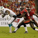 Nov 11, 2013; Tampa, FL, USA; Tampa Bay Buccaneers cornerback Darrelle Revis (24) tackles Miami Dolphins wide receiver Mike Wallace (11) dur Nov 11, 2013; Tampa, FL, USA; Tampa Bay Buccaneers cornerback Darrelle Revis (24) tackles Miami Dolphins wide receiver Mike Wallace (11) dur