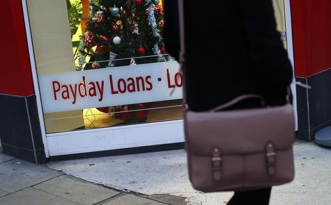 A payday loans sign is seen in the window of Speedy Cash in northwest London November 25, 2013. REUTERS/Suzanne Plunkett A payday loans sign is seen in the window of Speedy Cash in northwest London November 25, 2013. REUTERS/Suzanne Plunkett