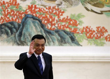 China's Premier Li Keqiang waves as he arrives for a news conference, after the closing ceremony of the Chinese National People's Congress ( China's Premier Li Keqiang waves as he arrives for a news conference, after the closing ceremony of the Chinese National People's Congress (
