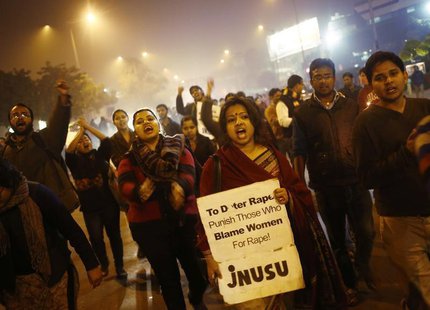 Demonstrators shout slogans during a candlelight vigil to mark the first anniversary of Delhi gang rape, in New Delhi December 16, 2013. A 2 Demonstrators shout slogans during a candlelight vigil to mark the first anniversary of Delhi gang rape, in New Delhi December 16, 2013. A 2