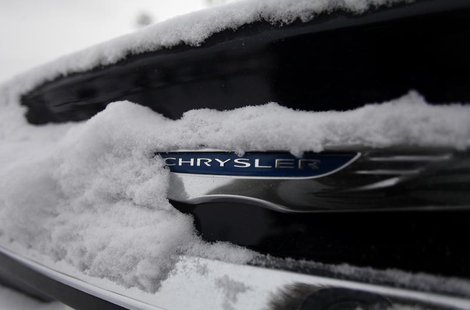 Snow surrounds the Chrysler logo displayed on a vehicle in the parking lot at Bill Snethkamp dealership in Detroit, Michigan January 2, 2014 Snow surrounds the Chrysler logo displayed on a vehicle in the parking lot at Bill Snethkamp dealership in Detroit, Michigan January 2, 2014