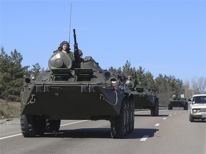 Ukrainian soldiers ride on military armoured personnel carriers on a road near Kiev March 13, 2014. REUTERS/Konstantin Grishin Ukrainian soldiers ride on military armoured personnel carriers on a road near Kiev March 13, 2014. REUTERS/Konstantin Grishin