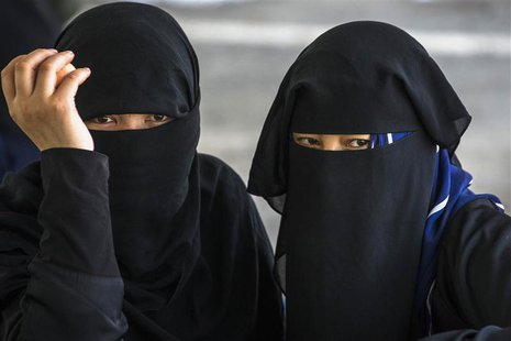 Suspected Uighurs from China's troubled far-western region of Xinjiang, look on inside a temporary shelter after they were detained at the i Suspected Uighurs from China's troubled far-western region of Xinjiang, look on inside a temporary shelter after they were detained at the i