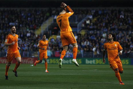 Real Madrid's Cristiano Ronaldo (C) celebrates after scoring a goal against Malaga during their Spanish First Division soccer match at La Ro Real Madrid's Cristiano Ronaldo (C) celebrates after scoring a goal against Malaga during their Spanish First Division soccer match at La Ro