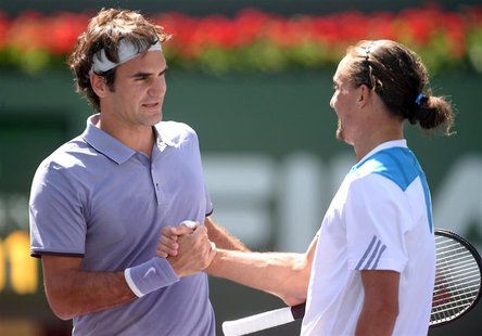 Mar 15, 2014; Indian Wells, CA, USA; Roger Federer (SUI), left, shakes hands with Alexandr Dolgopolov (UKR) after their semifinal match at t Mar 15, 2014; Indian Wells, CA, USA; Roger Federer (SUI), left, shakes hands with Alexandr Dolgopolov (UKR) after their semifinal match at t