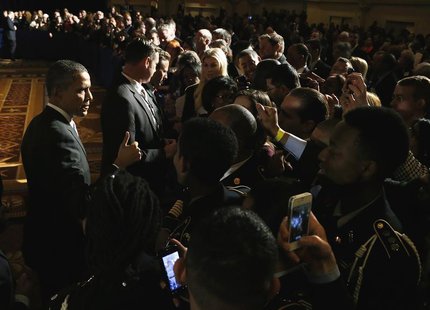 U.S. President Barack Obama (L) gives a thumbs-up to supporters after addressing the winter meeting of the Democratic National Committee in U.S. President Barack Obama (L) gives a thumbs-up to supporters after addressing the winter meeting of the Democratic National Committee in