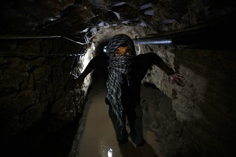 A Palestinian works inside a smuggling tunnel flooded by Egyptian forces, beneath the Egyptian-Gaza border in Rafah, in the southern Gaza St A Palestinian works inside a smuggling tunnel flooded by Egyptian forces, beneath the Egyptian-Gaza border in Rafah, in the southern Gaza St