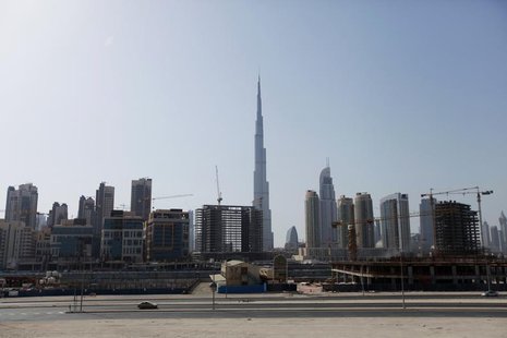 Construction cranes are seen near Burj Khalifa (C) in Dubai June 26, 2012. REUTERS/Jumana El Heloueh Construction cranes are seen near Burj Khalifa (C) in Dubai June 26, 2012. REUTERS/Jumana El Heloueh