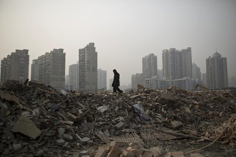 A man walks in an area where old residential buildings are being demolished to make room for new skyscrapers in central Shanghai January 20, A man walks in an area where old residential buildings are being demolished to make room for new skyscrapers in central Shanghai January 20,