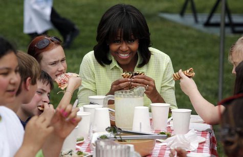 U.S. first lady Michelle Obama eats with school kids after they harvested vegetables from the summer crop from inside the White House Kitche U.S. first lady Michelle Obama eats with school kids after they harvested vegetables from the summer crop from inside the White House Kitche