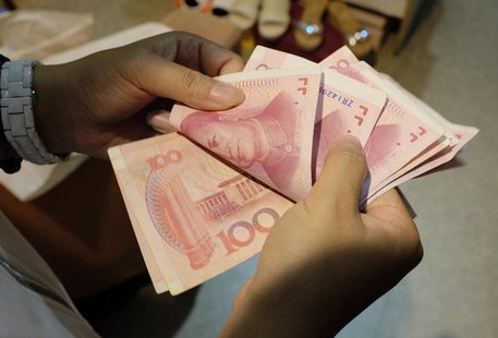 A woman counts Chinese yuan notes at a market in Beijing, July 1, 2013. REUTERS/Jason Lee A woman counts Chinese yuan notes at a market in Beijing, July 1, 2013. REUTERS/Jason Lee