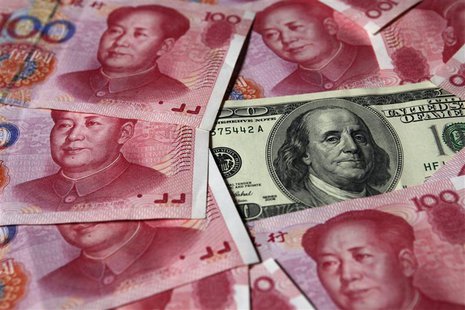 A U.S. $100 banknote is placed next to 100 yuan banknotes in Beijing in this illustrative file picture taken October 16, 2010. REUTERS/Petar A U.S. $100 banknote is placed next to 100 yuan banknotes in Beijing in this illustrative file picture taken October 16, 2010. REUTERS/Petar