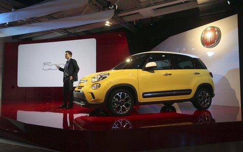 Jacob Nyborg, communication and marketing manager of Fiat Chrysler EMEA, stands next to the new Fiat 500L Living and Trekking model during a Jacob Nyborg, communication and marketing manager of Fiat Chrysler EMEA, stands next to the new Fiat 500L Living and Trekking model during a