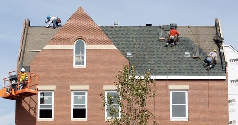 Builders work at the roof of a new housing construction site in Alexandria, Virginia October 17, 2012. REUTERS/Kevin Lamarque Builders work at the roof of a new housing construction site in Alexandria, Virginia October 17, 2012. REUTERS/Kevin Lamarque