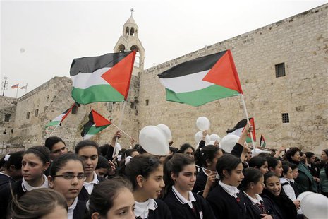 Palestinian girls hold flags and balloons in front of the Church of Nativity during a rally in the West Bank town of Bethlehem March 17, 201 Palestinian girls hold flags and balloons in front of the Church of Nativity during a rally in the West Bank town of Bethlehem March 17, 201