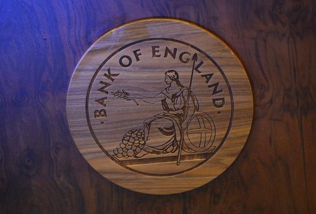 A wooden carving of the Bank of England logo is seen on a desk during the bank's quarterly inflation report news conference at the Bank of E A wooden carving of the Bank of England logo is seen on a desk during the bank's quarterly inflation report news conference at the Bank of E