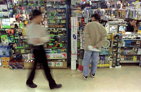 Shoppers browse carefully for bargains February 8 in Taipei's teeming Kwanghwa electronics market, known for its up-to-the-minute technologi Shoppers browse carefully for bargains February 8 in Taipei's teeming Kwanghwa electronics market, known for its up-to-the-minute technologi