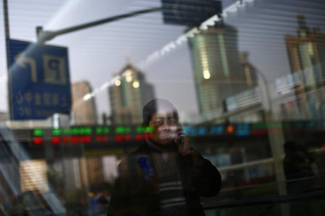 A man walks out of a subway station as he talk on the phone at the financial district of Pudong in Shanghai March 11, 2014. REUTERS/Carlos B A man walks out of a subway station as he talk on the phone at the financial district of Pudong in Shanghai March 11, 2014. REUTERS/Carlos B