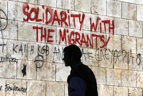 A man walks past graffiti outside the Athens' Academy in central Athens December 6, 2012. REUTERS/Yannis Behrakis A man walks past graffiti outside the Athens' Academy in central Athens December 6, 2012. REUTERS/Yannis Behrakis