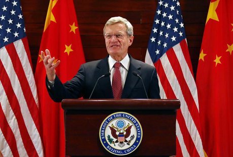 U.S. Ambassador to China Max Baucus gestures in front of Chinese and American national flags during a news conference at the U.S. Embassy, u U.S. Ambassador to China Max Baucus gestures in front of Chinese and American national flags during a news conference at the U.S. Embassy, u