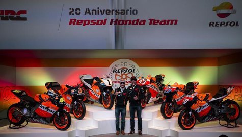 Spain's Marc Marquez (R), MotoGP 2013 World Champion, and his teammate compatriot Dani Pedrosa gesture during a ceremony to mark the 20th an Spain's Marc Marquez (R), MotoGP 2013 World Champion, and his teammate compatriot Dani Pedrosa gesture during a ceremony to mark the 20th an