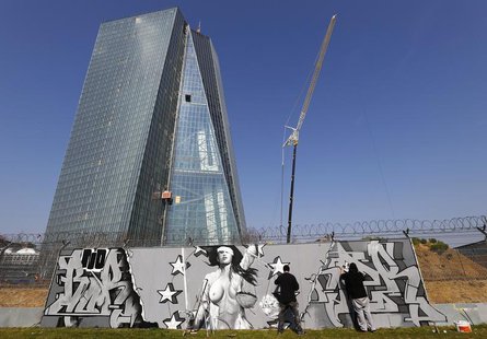 Artists Justus Becker, aka COR (L) and "Bobby Borderline" work on their graffiti mural on a fence surrounding the construction site for the Artists Justus Becker, aka COR (L) and "Bobby Borderline" work on their graffiti mural on a fence surrounding the construction site for the