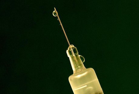 Flu vaccine drips out of a syringe as a nurse prepares for a patient at a clinic in central London November 22, 2005. - RTR1BGZ1 Flu vaccine drips out of a syringe as a nurse prepares for a patient at a clinic in central London November 22, 2005. - RTR1BGZ1