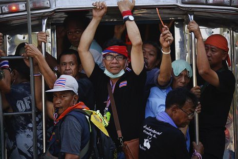 Anti-government protesters travel on a pick-up truck near the Interior Ministry building, which is being surrounded by fellow protesters, in Anti-government protesters travel on a pick-up truck near the Interior Ministry building, which is being surrounded by fellow protesters, in