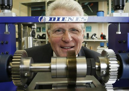 Bernd Supe-Dienes, director of the 1913 founded German industrial knife manufacturer Dienes poses for a picture behind an industrial knife m Bernd Supe-Dienes, director of the 1913 founded German industrial knife manufacturer Dienes poses for a picture behind an industrial knife m