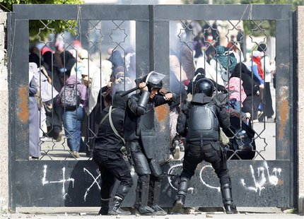 Riot police attempt to break open the entrance of the al-Azhar University Campus during clashes with female university students, who are sup Riot police attempt to break open the entrance of the al-Azhar University Campus during clashes with female university students, who are sup