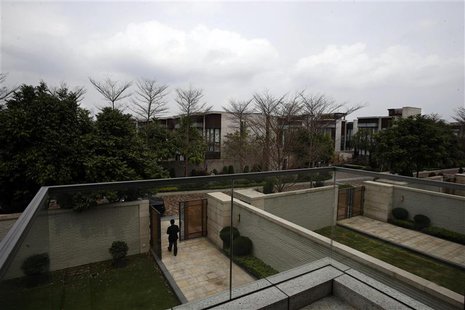 A property agent walks out of a house for sale by a mainland Chinese inside a luxury estate in Hong Kong in this March 18, 2014 file photo. A property agent walks out of a house for sale by a mainland Chinese inside a luxury estate in Hong Kong in this March 18, 2014 file photo.