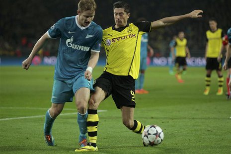 Zenit St Petersburg's Tomas Hubocan (L) is tackled by Borussia Dortmund's Robert Lewandowski during their Champions League round of 16 secon Zenit St Petersburg's Tomas Hubocan (L) is tackled by Borussia Dortmund's Robert Lewandowski during their Champions League round of 16 secon