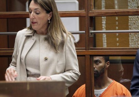 Former NFL player Darren Sharper looks up at defense attorney Blair Berk as he appears for a court hearing on rape charges in Los Angeles, C Former NFL player Darren Sharper looks up at defense attorney Blair Berk as he appears for a court hearing on rape charges in Los Angeles, C