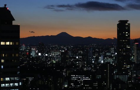 The silhouette of Japan's highest Mt. Fuji is seen beyond buildings in Tokyo November 15, 2012. REUTERS/Toru Hanai The silhouette of Japan's highest Mt. Fuji is seen beyond buildings in Tokyo November 15, 2012. REUTERS/Toru Hanai