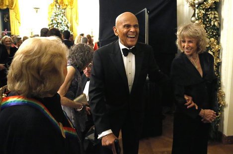 Harry Belafonte (C) laughs with a fellow audience member as they depart after a reception for the 2013 Kennedy Center Honors recipients at t Harry Belafonte (C) laughs with a fellow audience member as they depart after a reception for the 2013 Kennedy Center Honors recipients at t