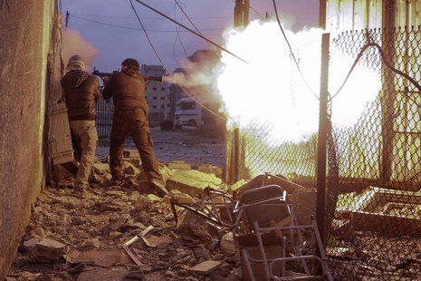 Syrian rebels fire a rocket-propelled grenade (RPG) towards a government controlled army checkpoint in the Ain Tarma neighborhood of Damascu Syrian rebels fire a rocket-propelled grenade (RPG) towards a government controlled army checkpoint in the Ain Tarma neighborhood of Damascu