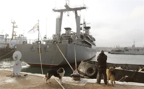 A man looks at the Ukrainian ship Slavutich (C) blocked by two Russian ships at the harbour in Sevastopol, March 20, 2014. REUTERS/Vasily Fe A man looks at the Ukrainian ship Slavutich (C) blocked by two Russian ships at the harbour in Sevastopol, March 20, 2014. REUTERS/Vasily Fe
