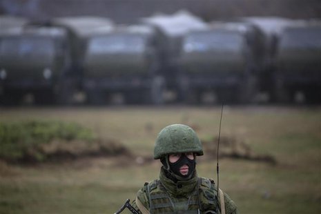 An armed man, believed to be a Russian serviceman, stands guard near a military base in Perevalnoye, near the Crimean city of Simferopol, Ma An armed man, believed to be a Russian serviceman, stands guard near a military base in Perevalnoye, near the Crimean city of Simferopol, Ma