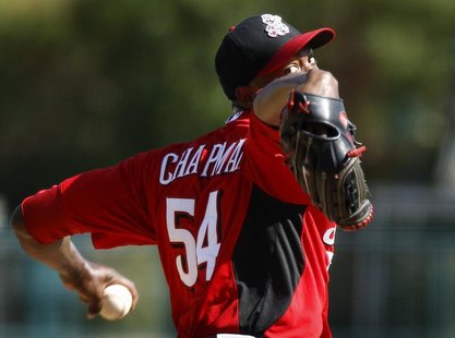 Cincinnati Reds' Aroldis Chapman delivers a pitch against the Los Angeles Dodgers during the sixth inning of their MLB Cactus League spring Cincinnati Reds' Aroldis Chapman delivers a pitch against the Los Angeles Dodgers during the sixth inning of their MLB Cactus League spring