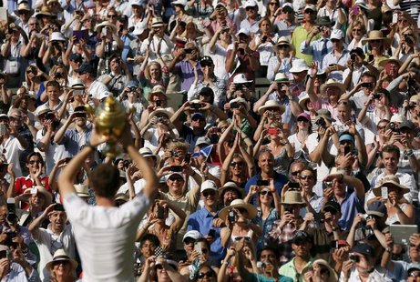 Andy Murray of Britain holds the winners trophy up to the spectators after defeating Novak Djokovic of Serbia in their men's singles final t Andy Murray of Britain holds the winners trophy up to the spectators after defeating Novak Djokovic of Serbia in their men's singles final t