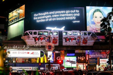 A message for passengers onboard the missing Malaysia Airlines Flight MH370 is seen on big screen in Kuala Lumpur March 20, 2014. REUTERS/Sa A message for passengers onboard the missing Malaysia Airlines Flight MH370 is seen on big screen in Kuala Lumpur March 20, 2014. REUTERS/Sa