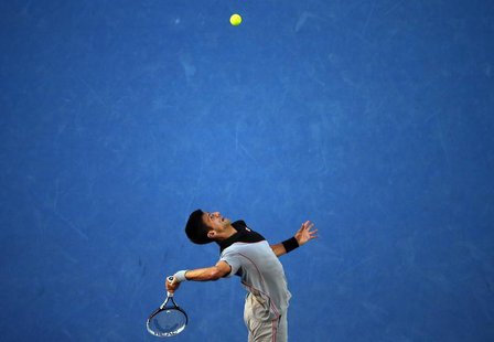 Novak Djokovic of Serbia serves to Stanislas Wawrinka of Switzerland during their men's singles quarter-final tennis match at the Australian Novak Djokovic of Serbia serves to Stanislas Wawrinka of Switzerland during their men's singles quarter-final tennis match at the Australian