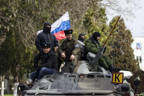 Pro-Russian supporters sit on top of a Ukrainian APC after breaking into the territory of the naval headquarters in Sevastopol, March 19, 2014. Pro-Russian supporters sit on top of a Ukrainian APC after breaking into the territory of the naval headquarters in Sevastopol, March 19, 2014.