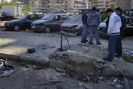 Civilians inspect a site of a roadside bomb, that exploded when the army was patrolling overnight the area in Tripoli, northern Lebanon Marc Civilians inspect a site of a roadside bomb, that exploded when the army was patrolling overnight the area in Tripoli, northern Lebanon Marc