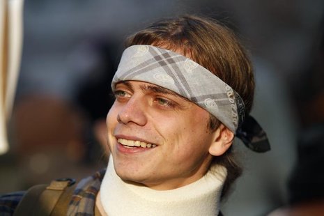 Marine veteran Scott Olsen, who suffered a head injury at the October 25 Occupy Oakland protest, smiles as he takes part in the Occupy movem Marine veteran Scott Olsen, who suffered a head injury at the October 25 Occupy Oakland protest, smiles as he takes part in the Occupy movem